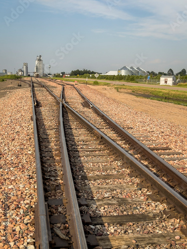 Obraz na plátně railroad tracks leading to silo and grain elevators in a rural town in Nebraska