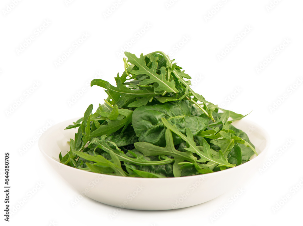 lettuce leaves in a white plate. Fresh romaine lettuce and arugula close-up in a glass bowl and on a white background lettuce leaves in a white plate. Fresh romaine lettuce and arugula close-up in a glass bowl and on a white background