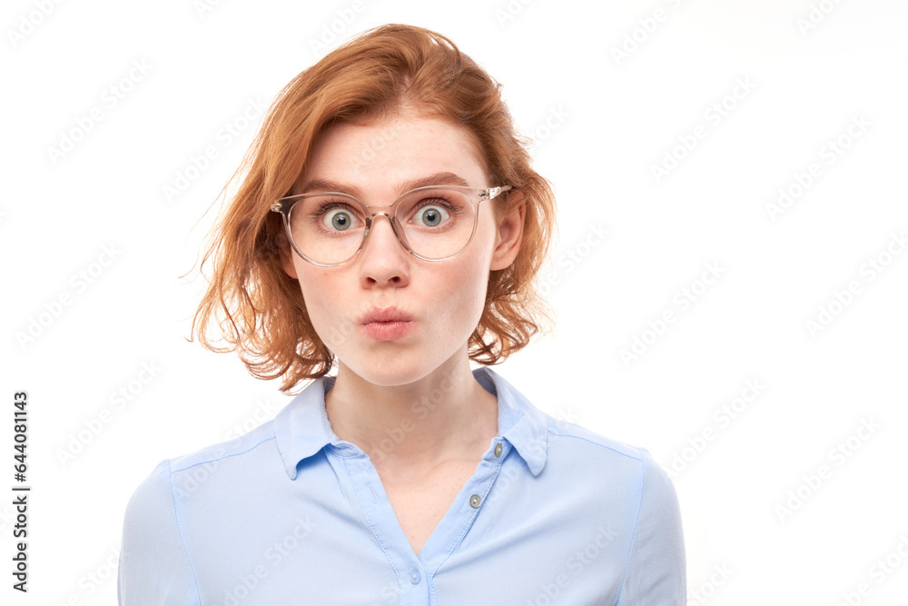Portrait of surprised young woman with bulging eyes shocked by news, shyly looking at camera isolated over white studio background.