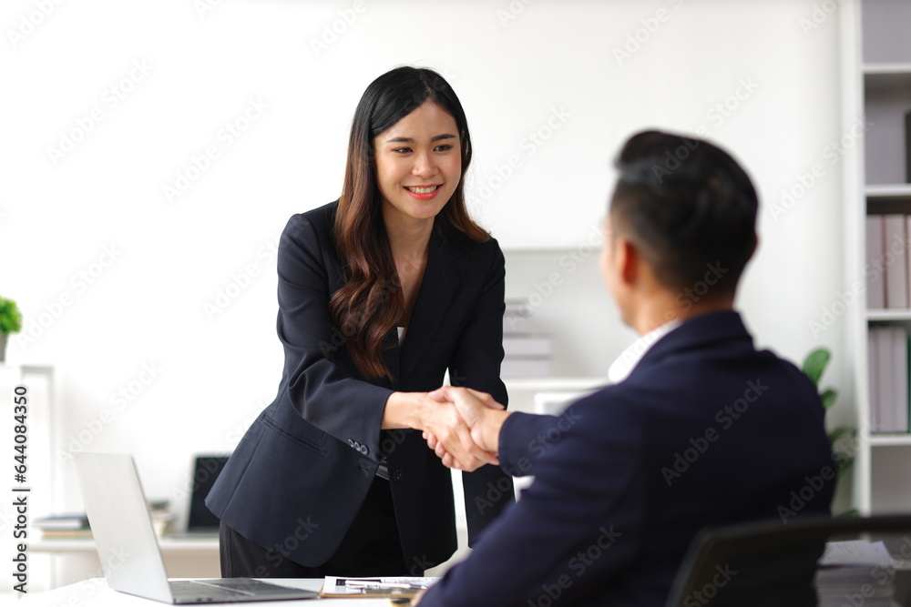 Business partners and colleagues shaking hands at work cooperation. Job applicant shaking hands with executives in office room at job interview. Business partners and colleagues shaking hands at work cooperation. Job applicant shaking hands with executives in office room at job interview.