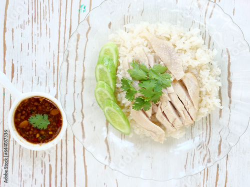 steamed rice topped with chicken delicious, dipping sauce