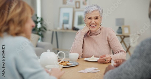 Tea, happy and retirement with friends and playing cards in living room for relax, diversity and poker. Games, smile and community with group of old people in nursing home for party and celebration