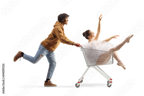 African american guy pushing a ballerina inside a shopping cart