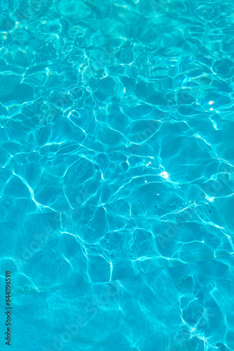 Azure transparent texture of water in a blue pool with splashes from the sun © ir1ska
