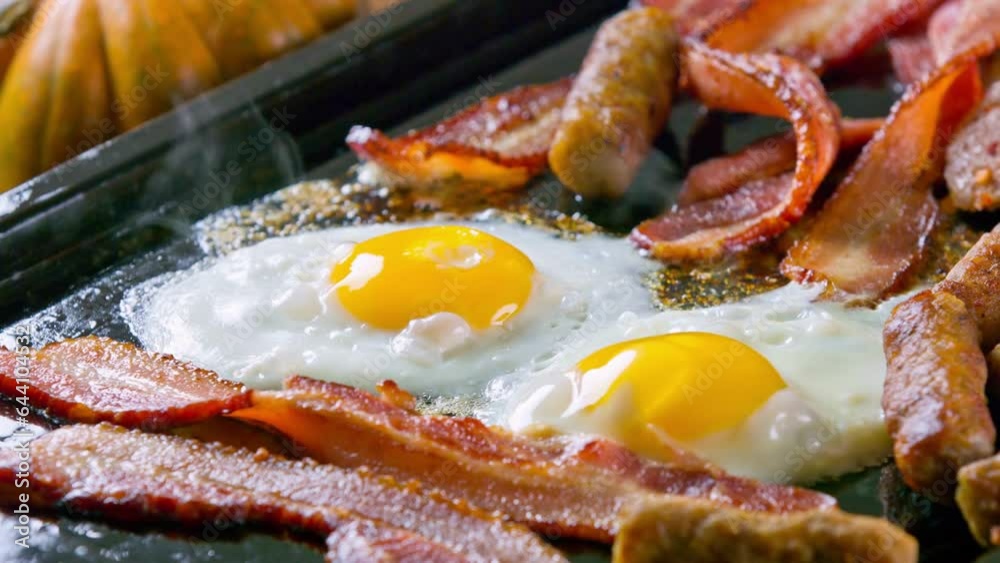 Morning Feast: 4K Video of Cooking Eggs, Sausage, and Bacon