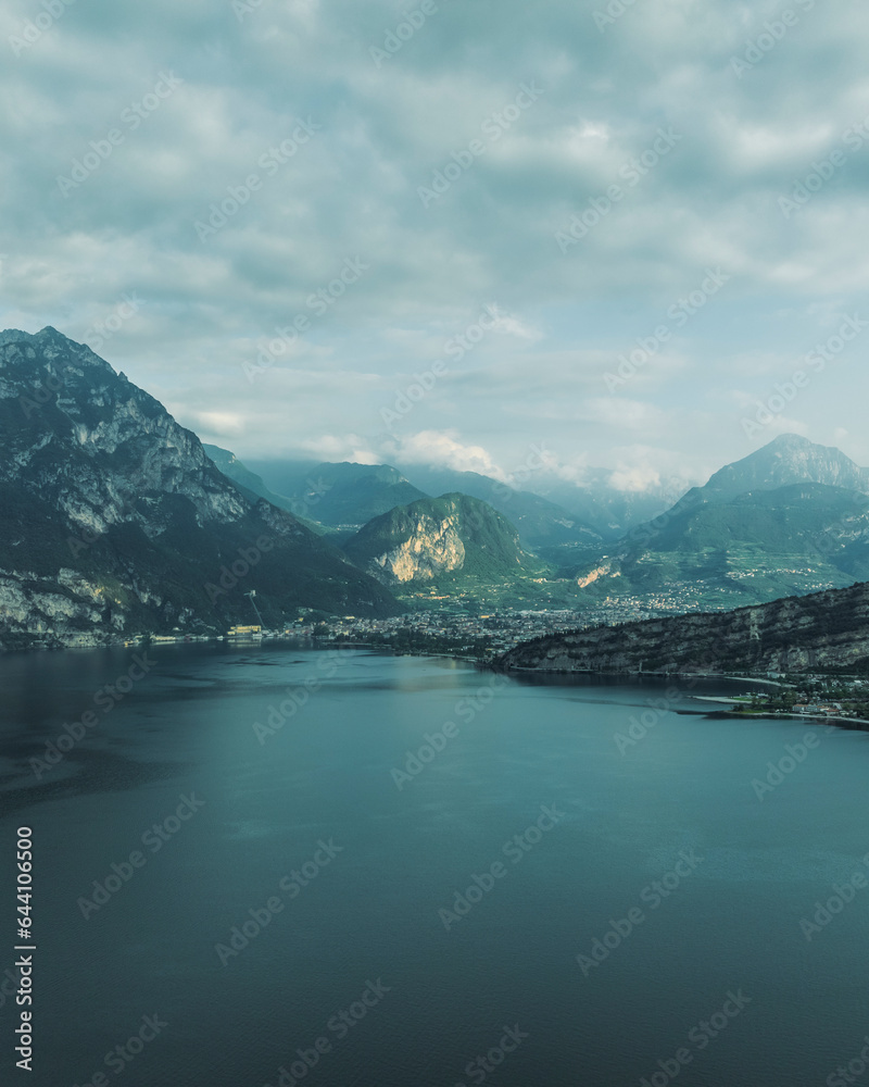 Aeerial view of Riva del Garda, a small town along the Garda lake at sunset with mountain in background, Trentino, Italy. Aeerial view of Riva del Garda, a small town along the Garda lake at sunset with mountain in background, Trentino, Italy.