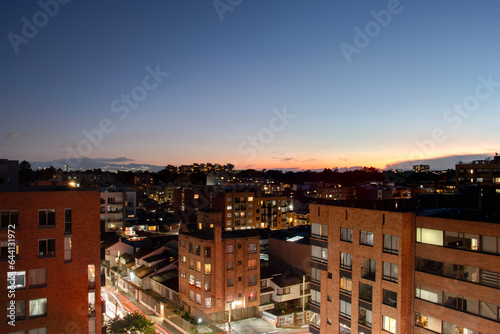 Beautiful orange and blue twilight cityscape at bogota colombia north neightborhood photo