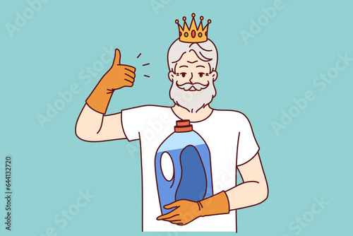 Older man holds bottle of detergent and gives thumbs up, recommending quality liquid fabric softener. Bearded pensioner with golden crown on head advertises new brand of detergent.