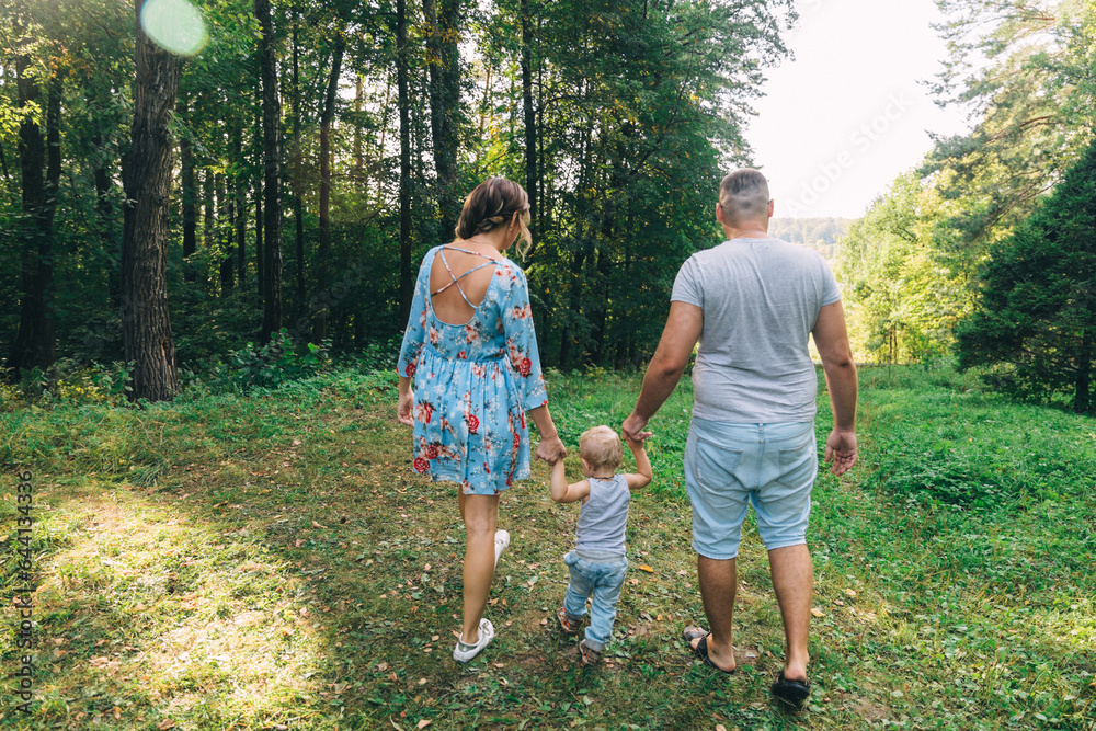 husband and wife with baby on a walk view from bullying in the woods husband and wife with baby on a walk view from bullying in the woods