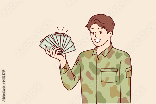 Man in military uniform holds money, calling to become soldier of army for large income or preferences. Employee of private military company in camouflage clothes boasts of high salary