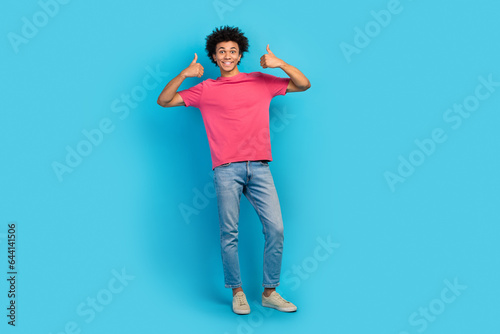 Full body photo of attractive young man showing double thumbs up good quality wear trendy pink clothes isolated on blue color background