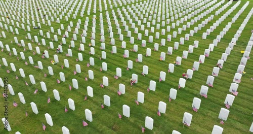 Sarasota National Cemetery with many white tombstones on green grass lawn. Memorial Day concept