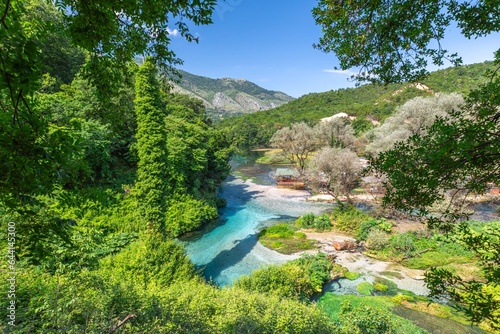 The mesmerizing Blue Eye water spring natural wonder in southern Albania, known for its giant, vibrant eye-like appearance, can be admired from an aerial perspective.