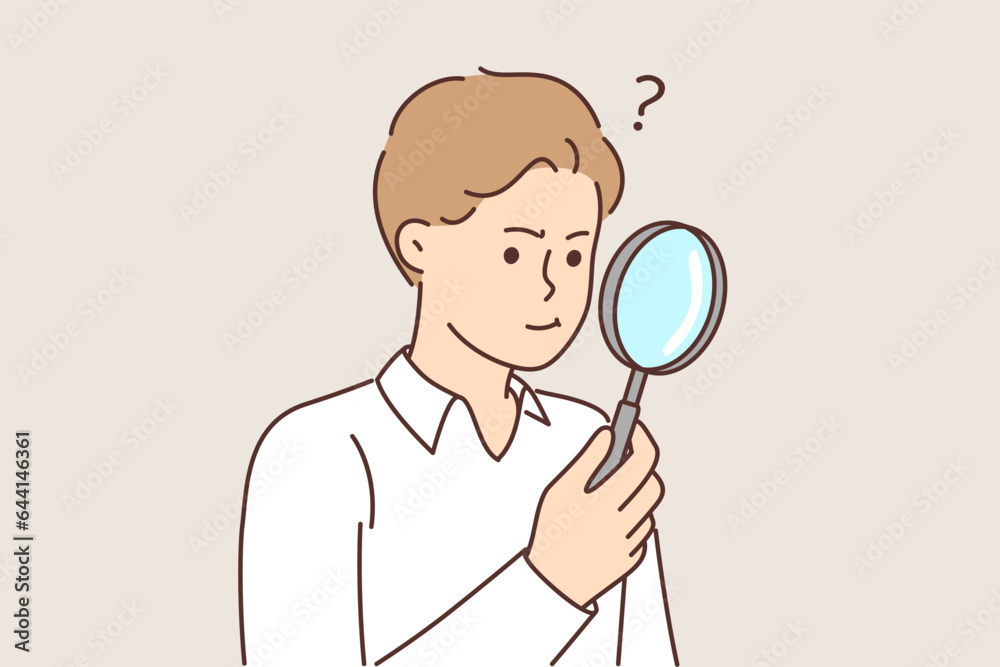 Man with magnifying glass works as private detective and tries to find small clues with loupe Man with magnifying glass works as private detective and tries to find small clues with loupe