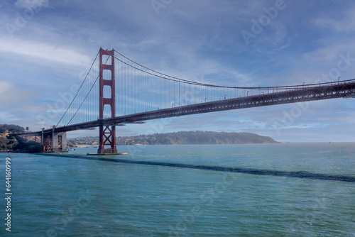 San Francisco, CA, USA - July 13, 2023: Golden Gate bridge south landing with 1 tower under blue cloudscape and green ocean water. © Klodien