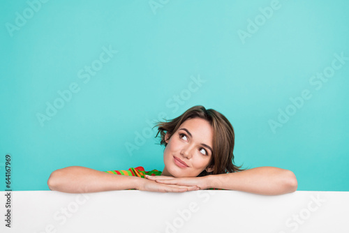 Photo of minded pretty person look interested empty space advert isolated on cyan color background