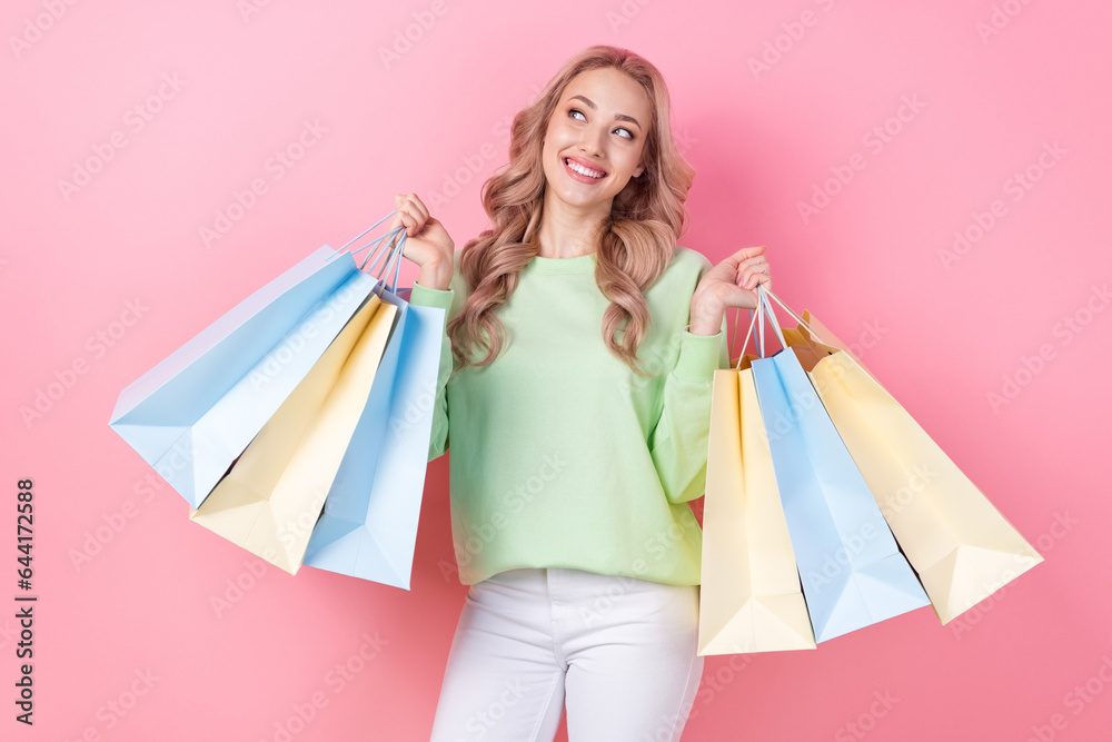 Poster of charming girlfriend spend her holidays in shopping mall buying clothes bargains holding bags isolated on pink color background Poster of charming girlfriend spend her holidays in shopping mall buying clothes bargains holding bags isolated on pink color background