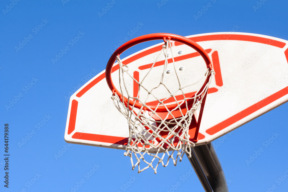 Red basketball basket against the sky, sports equipment, side view on the right