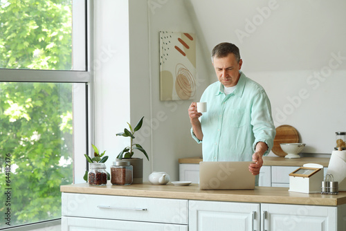 Mature man with cup of coff...