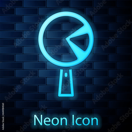 Glowing neon Omelette in frying pan icon isolated on brick wall background. Omelet in a skillet. Vector