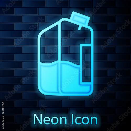 Glowing neon Printer ink bottle icon isolated on brick wall background. Vector
