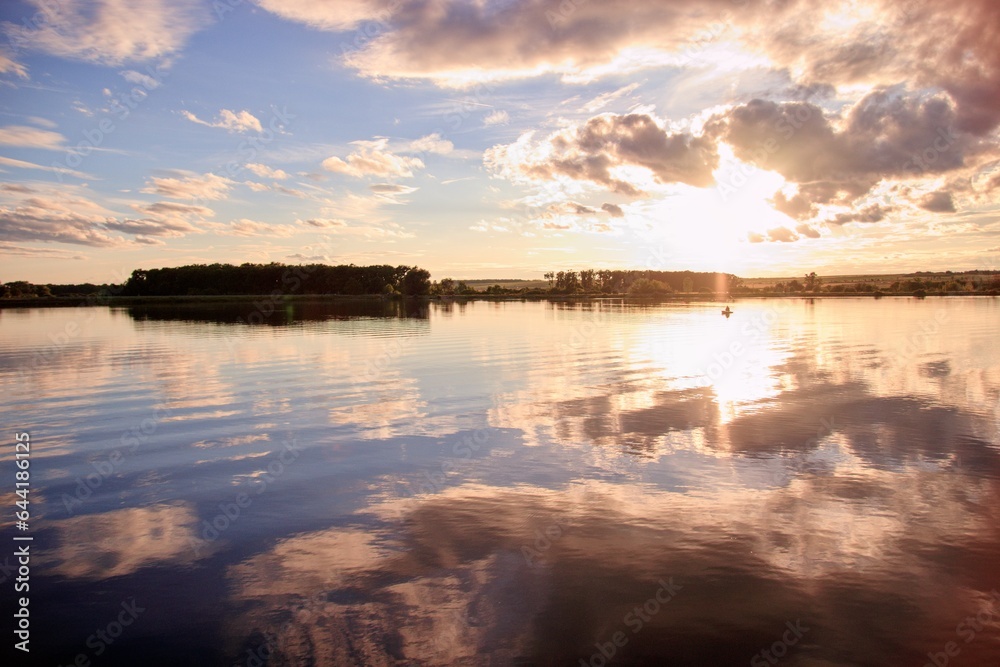Fototapeta premium A stunning colorful sunset above the lake near Palava hills at South Moravia, Czech republic