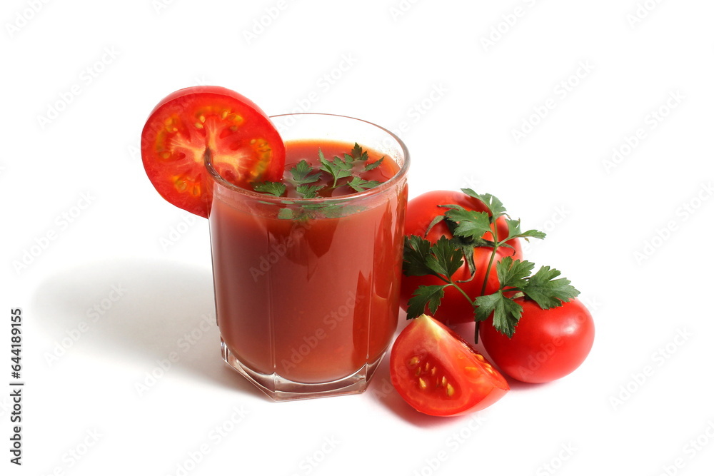 On a white background is a glass of tomato juice with tomatoes and herbs. On a white background is a glass of tomato juice with tomatoes and herbs.