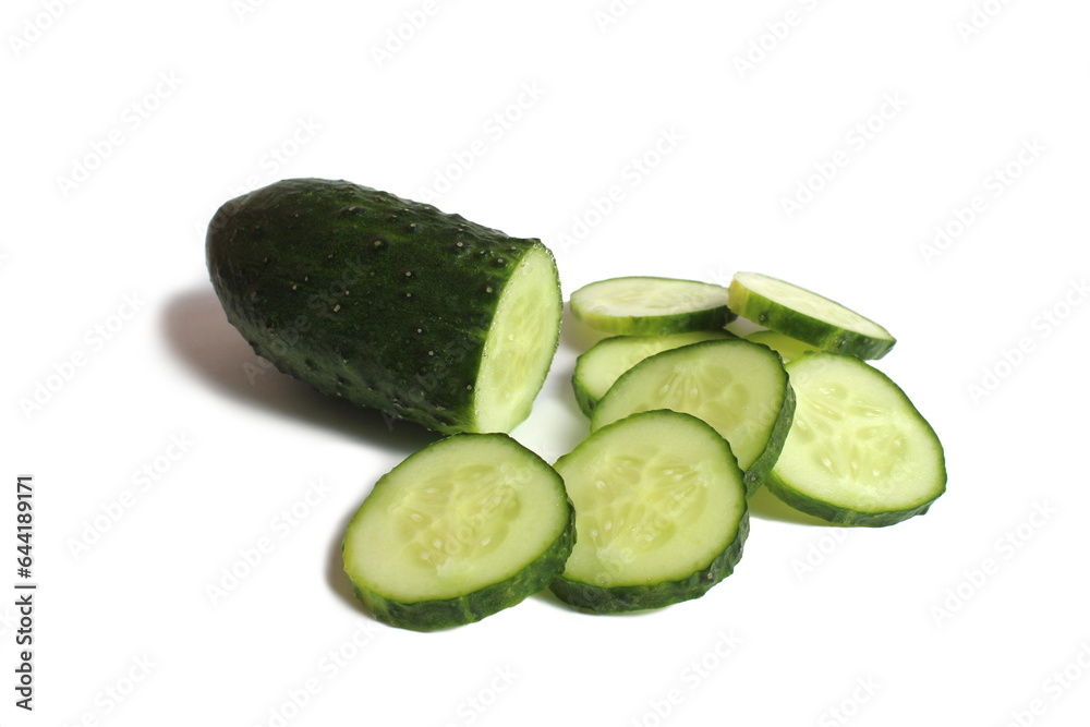 Many pieces of sliced cucumber lie on a white background. Many pieces of sliced cucumber lie on a white background.
