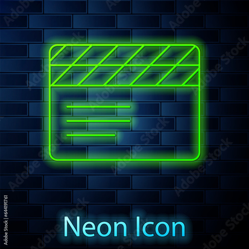 Glowing neon line Movie clapper icon isolated on brick wall background. Film clapper board. Clapperboard sign. Cinema production or media industry. Vector