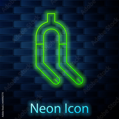 Glowing neon line Bicycle suspension fork icon isolated on brick wall background. Sport transportation spare part steering wheel. Vector