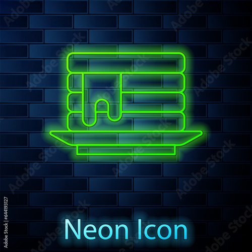 Glowing neon line Stack of pancakes with honey icon isolated on brick wall background. Breakfast concept. Vector