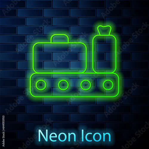 Glowing neon line Airport conveyor belt with passenger luggage, suitcase, bag, baggage icon isolated on brick wall background. Vector