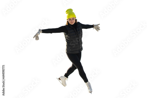 Healthy lifestyle hobby in winter. She is dressed in warm sports clothes and a yellow hat. A full-length woman is skating for ice.