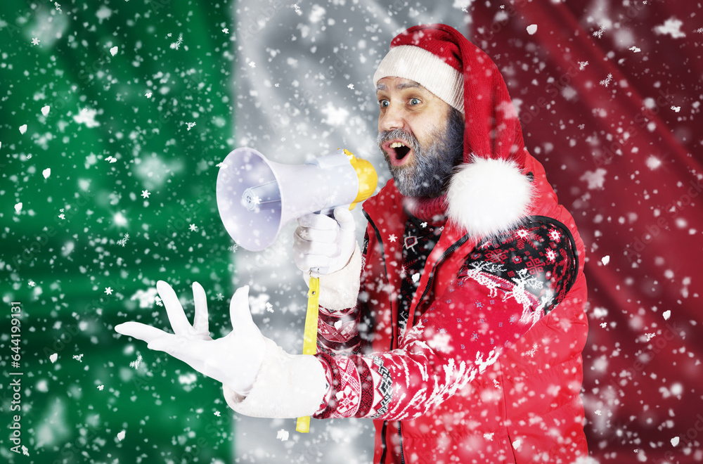 Santa Claus shouts into a megaphone and shows a hand gesture against the background of the flag of Italy Santa Claus shouts into a megaphone and shows a hand gesture against the background of the flag of Italy