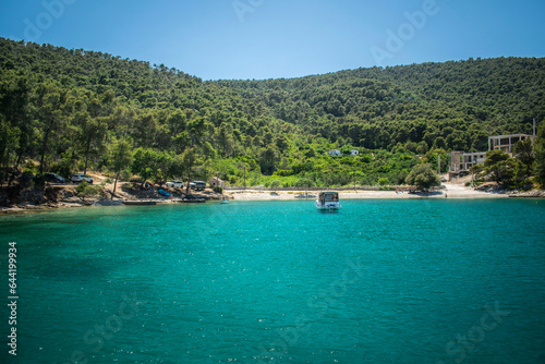 blue bay with boat and trees