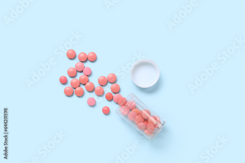 Jar with scattered pills on...