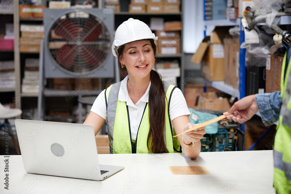 worker giving or taking envelope to coworker in the warehouse storage worker giving or taking envelope to coworker in the warehouse storage