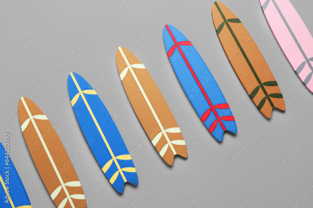 Different mini surfboards on grey background