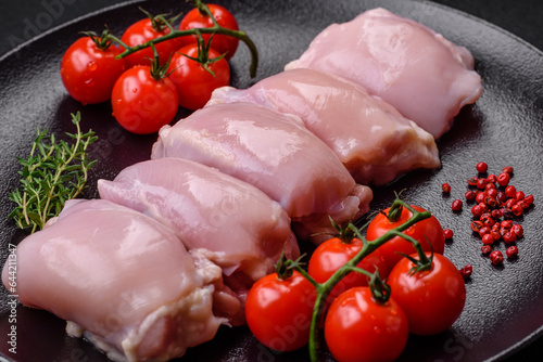 Fresh raw chicken thigh fillets with salt, spices and herbs