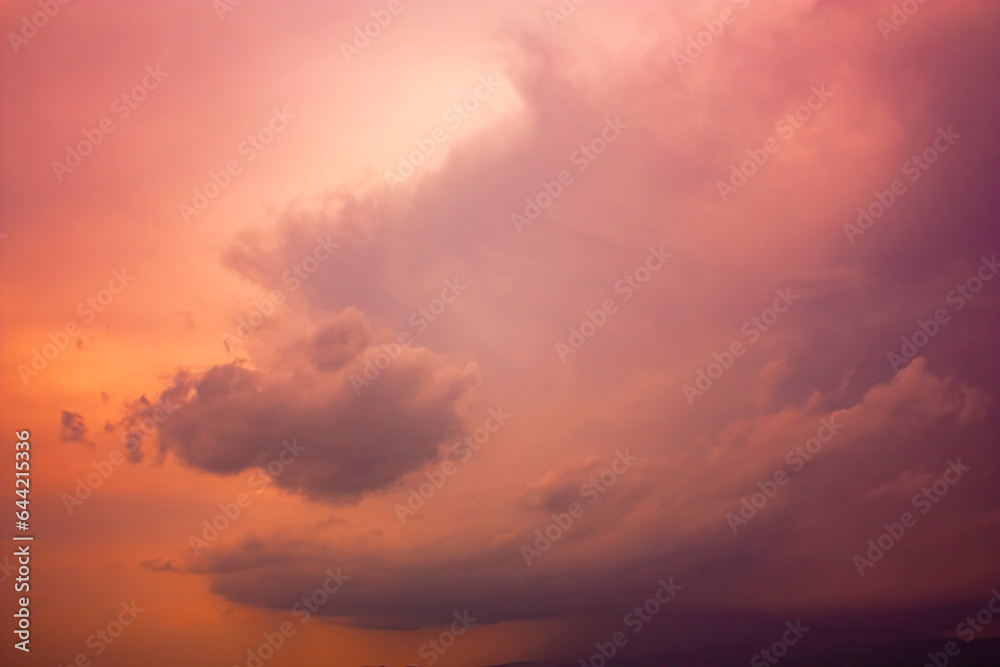 Photo of rainy clouds and pink sky.