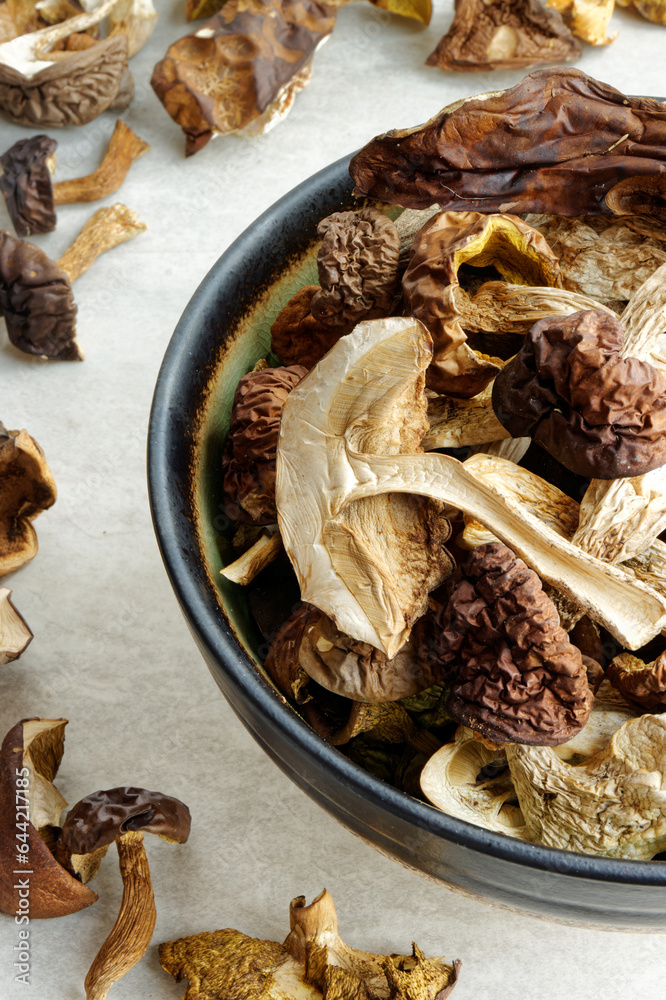 Dried edible forest mushrooms in a bowl. European cuisine ingredient. Dried edible forest mushrooms in a bowl. European cuisine ingredient.