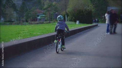 Wallpaper Mural Energetic little boy riding bicycle outdoors at park, child wearing protective helmet rides bike Torontodigital.ca