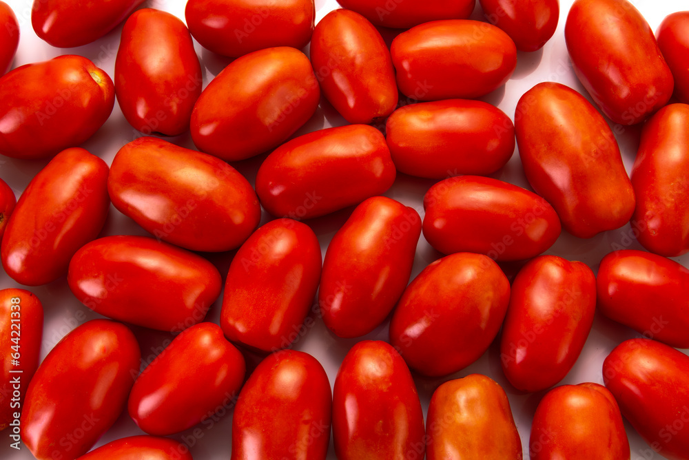 Red plum tomatoes arranged as background seen in full frame top view Red plum tomatoes arranged as background seen in full frame top view