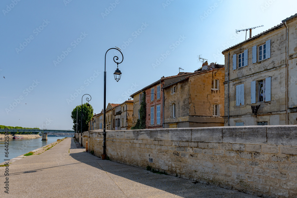 View on Rhone river, old streets and houses in ancient french town Arles, touristic destination with Roman ruines, Bouches-du-Rhone, France
