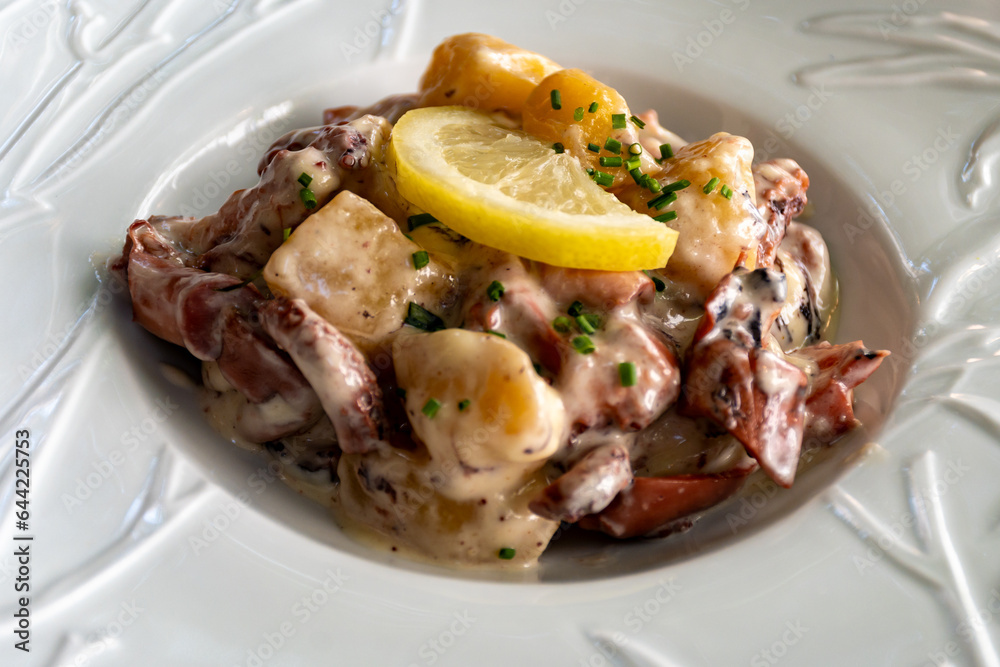 Tastes od Camargue, Provence, hot dish salad with boiled octopus, potatoes and white sauce, served in French restaurant Tastes od Camargue, Provence, hot dish salad with boiled octopus, potatoes and white sauce, served in French restaurant