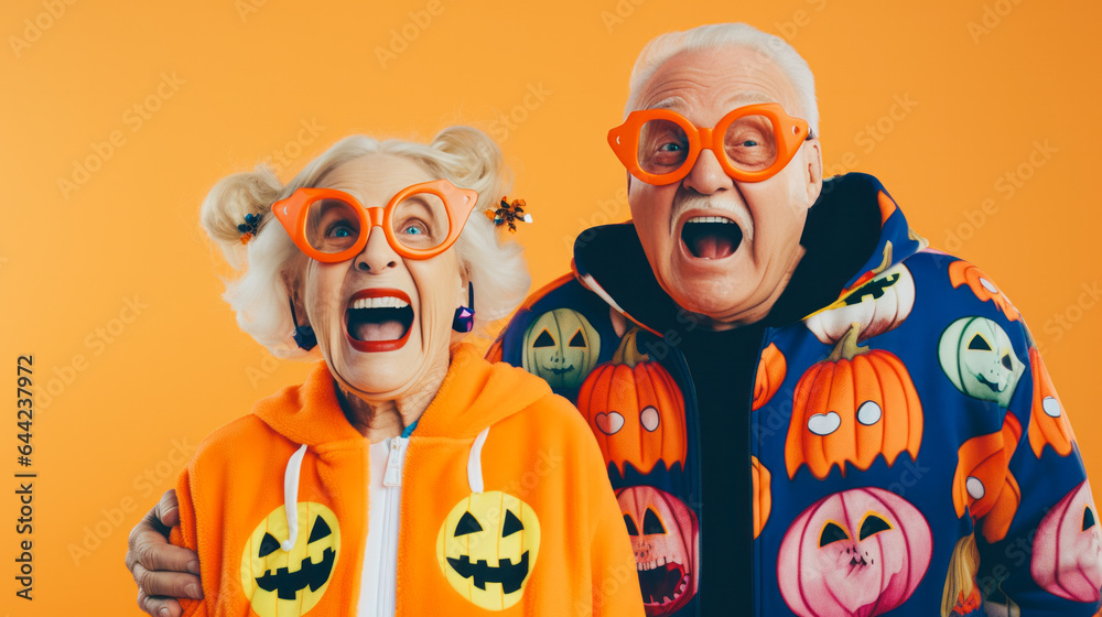Adorable goofy older couple having fun and posing dressed in hoodies and sunglasses with a background featuring Halloween pumpkin motifs. Orange and purple tones. Generative AI. Adorable goofy older couple having fun and posing dressed in hoodies and sunglasses with a background featuring Halloween pumpkin motifs. Orange and purple tones. Generative AI.
