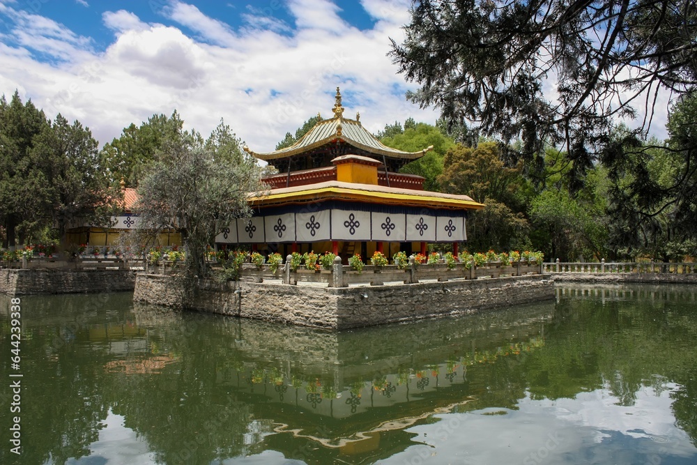 The beautiful Tsokyil Phodrong pavilion rests within Norbulingka, situated amidst the serene waters of a lake in Lhasa, Tibet.