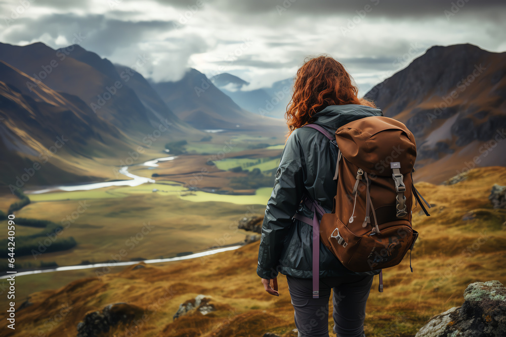a woman enjoying the scenic view of a breathtaking valley a woman enjoying the scenic view of a breathtaking valley