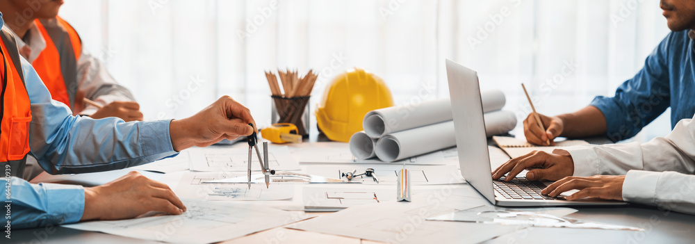 Architect or engineer working on building blueprint, contractor designing and drawing blueprint layout with tool for construction project. Civil engineer and architecture design concept. Insight - obrazy, fototapety, plakaty 