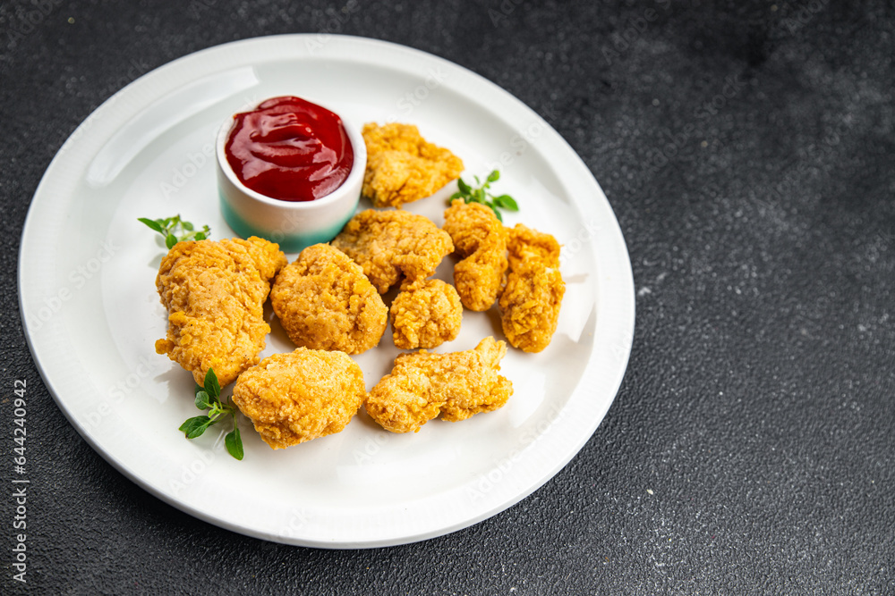 chicken nuggets deep-fried tomato sauce meat ready to eat meal food snack on the table copy space food background rustic top view chicken nuggets deep-fried tomato sauce meat ready to eat meal food snack on the table copy space food background rustic top view